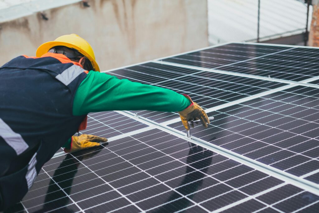 workman working on a solar panel